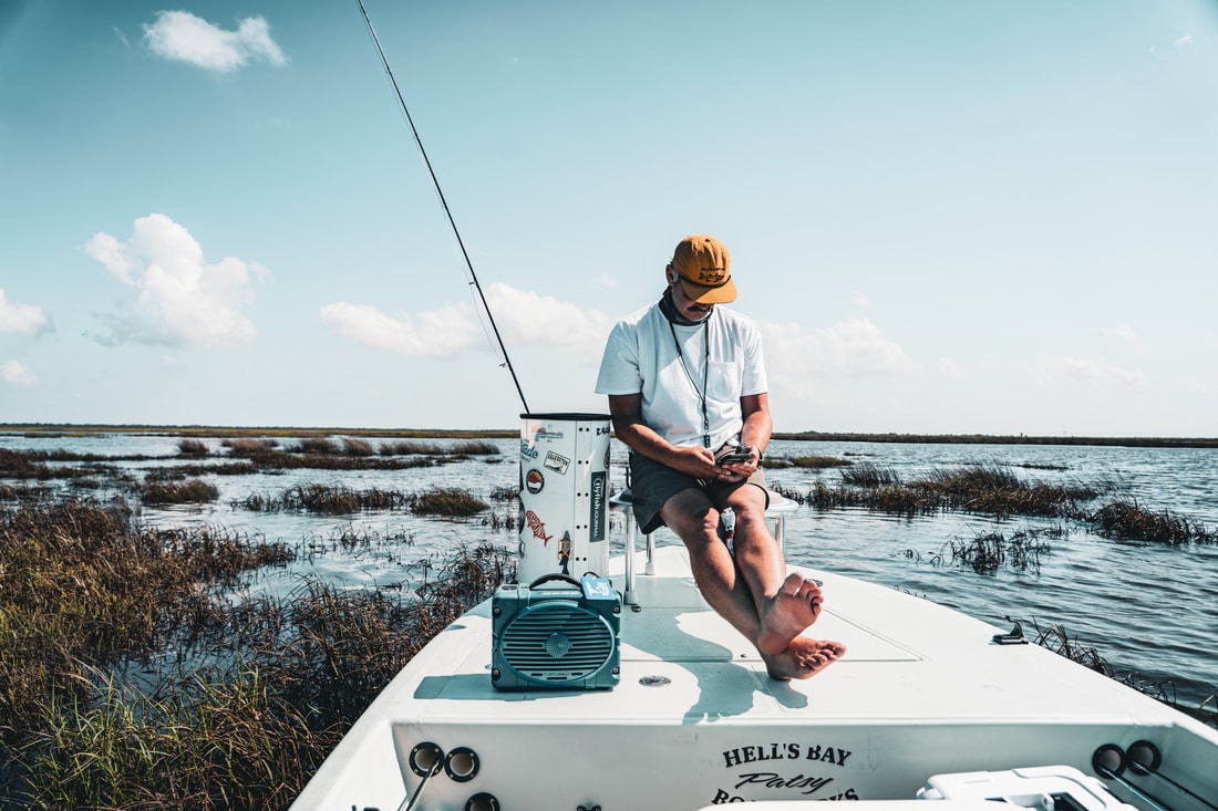 Man on a Hell's Bay fishing boat in shallow coastal waters