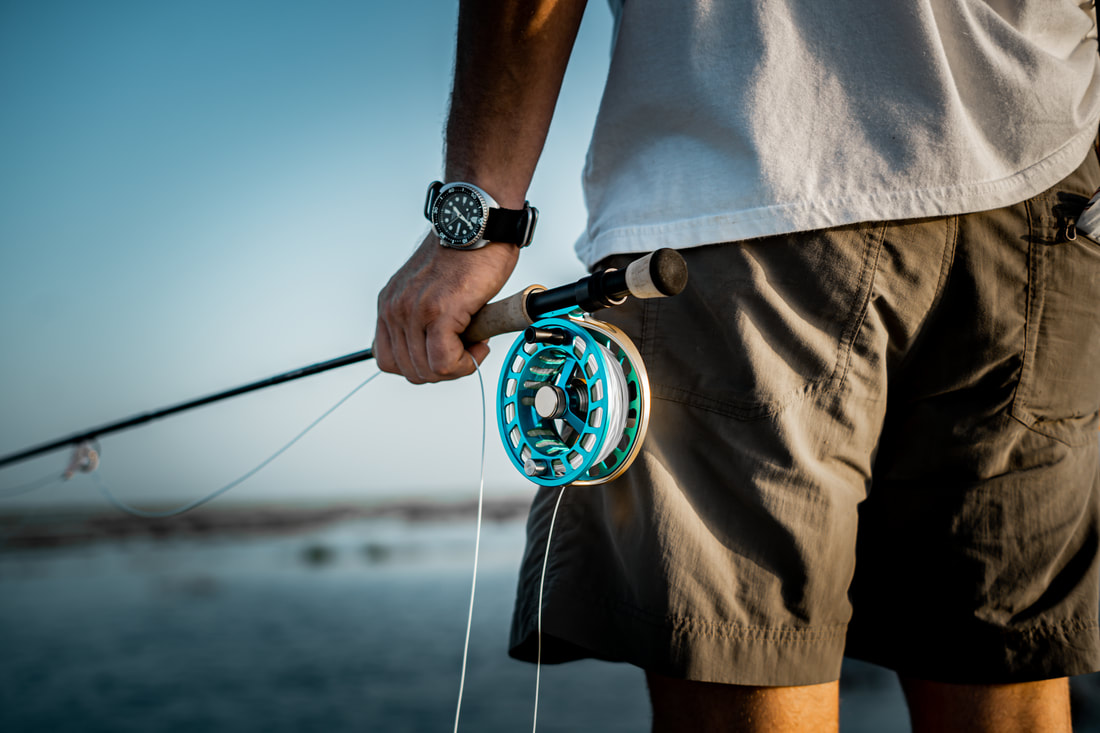 Close-up of a turquoise fly fishing reel